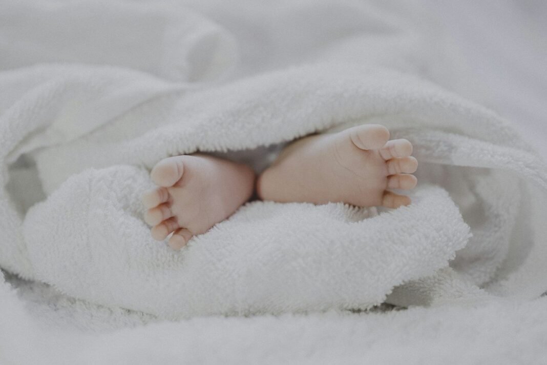 PCOS and Pregnancy: How It Affects Fertility and What Helps Newborn baby feet resting on a soft white towel, illustrating PCOS and pregnancy hope