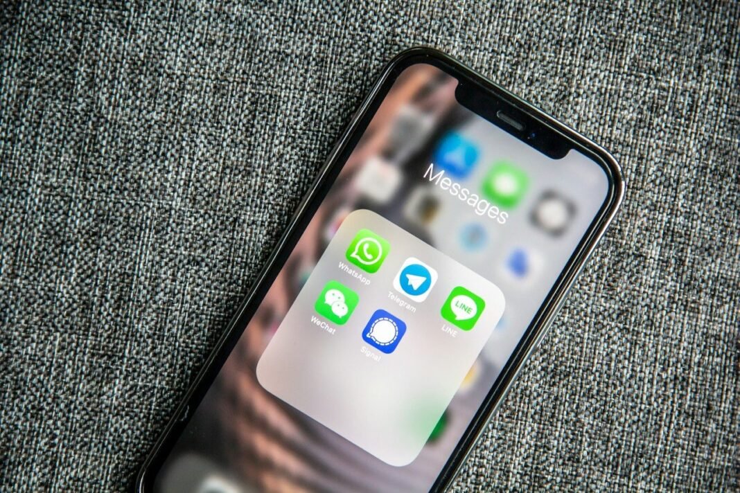 How to Transfer WhatsApp Chats to a New Phone Phone showing WhatsApp and messaging apps, ready to transfer WhatsApp to new phone
