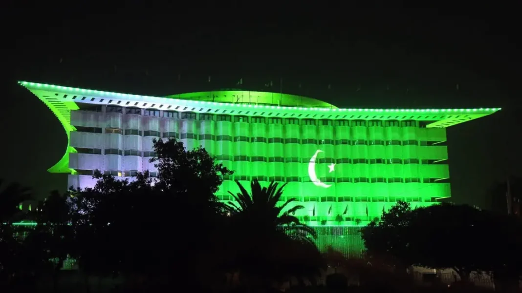 List of Autonomous Bodies in Pakistan: WAPDA, PIA, NHA & More WAPDA House building in Lahore lit green at night with crescent projection